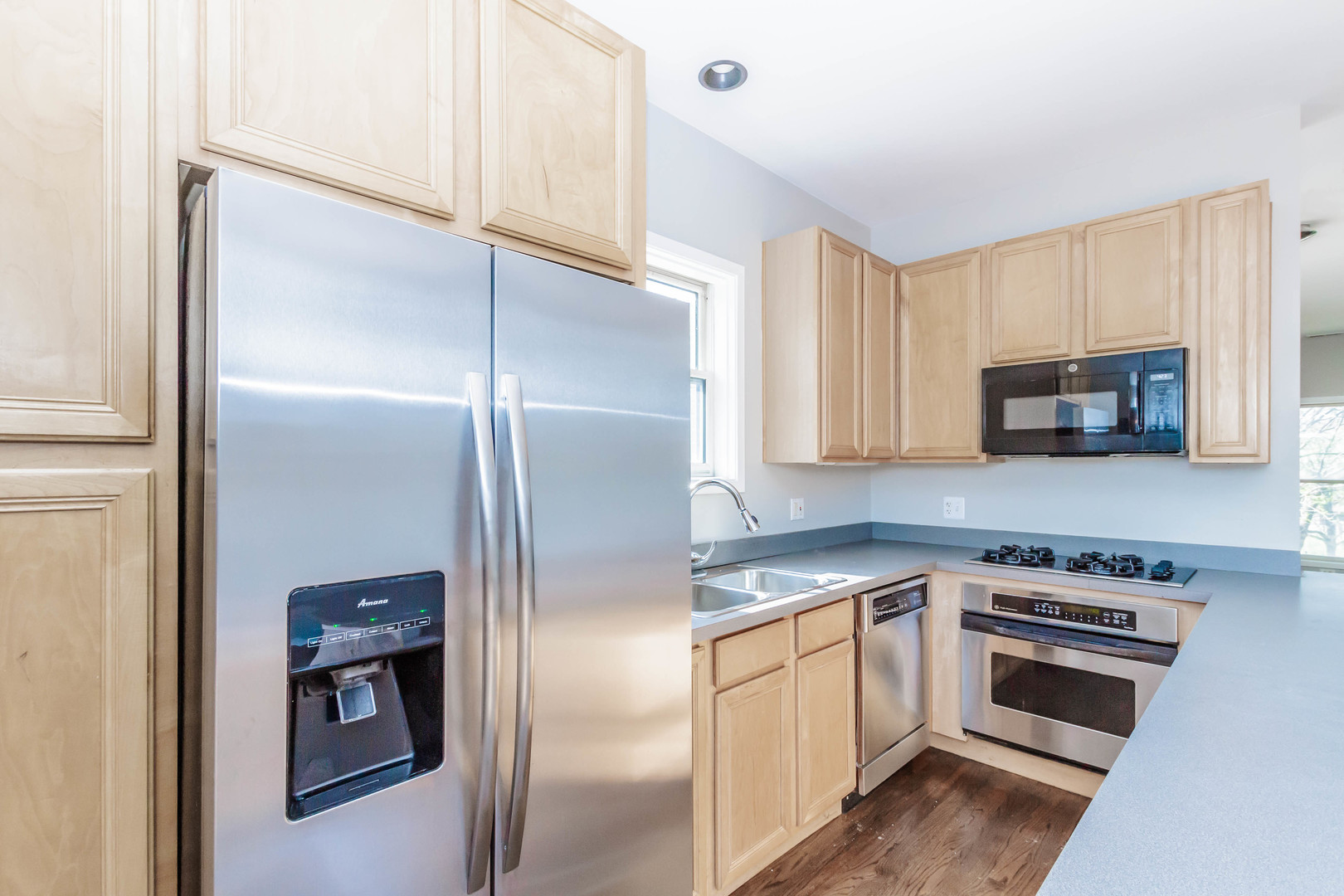 1443 West Fillmore Street Chicago, IL 60607 - Photo 20 of 37 a kitchen with white cabinets and stainless steel appliances