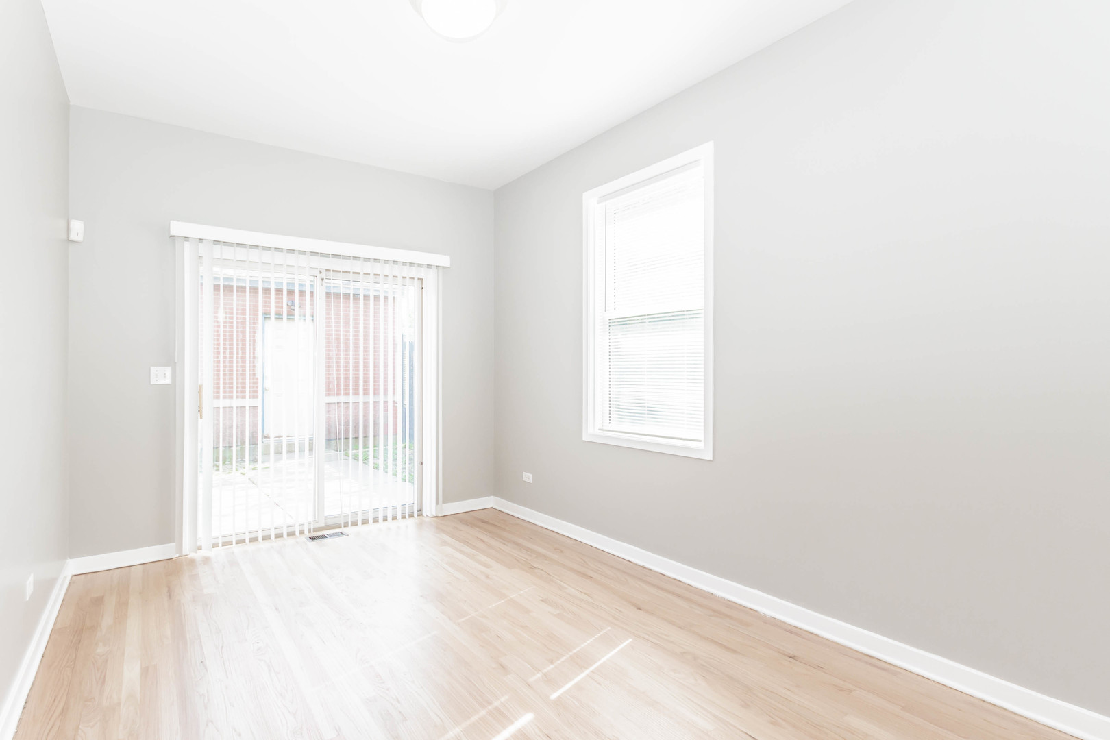 1443 West Fillmore Street Chicago, IL 60607 - Photo 6 of 37 an empty room with wooden floor and windows