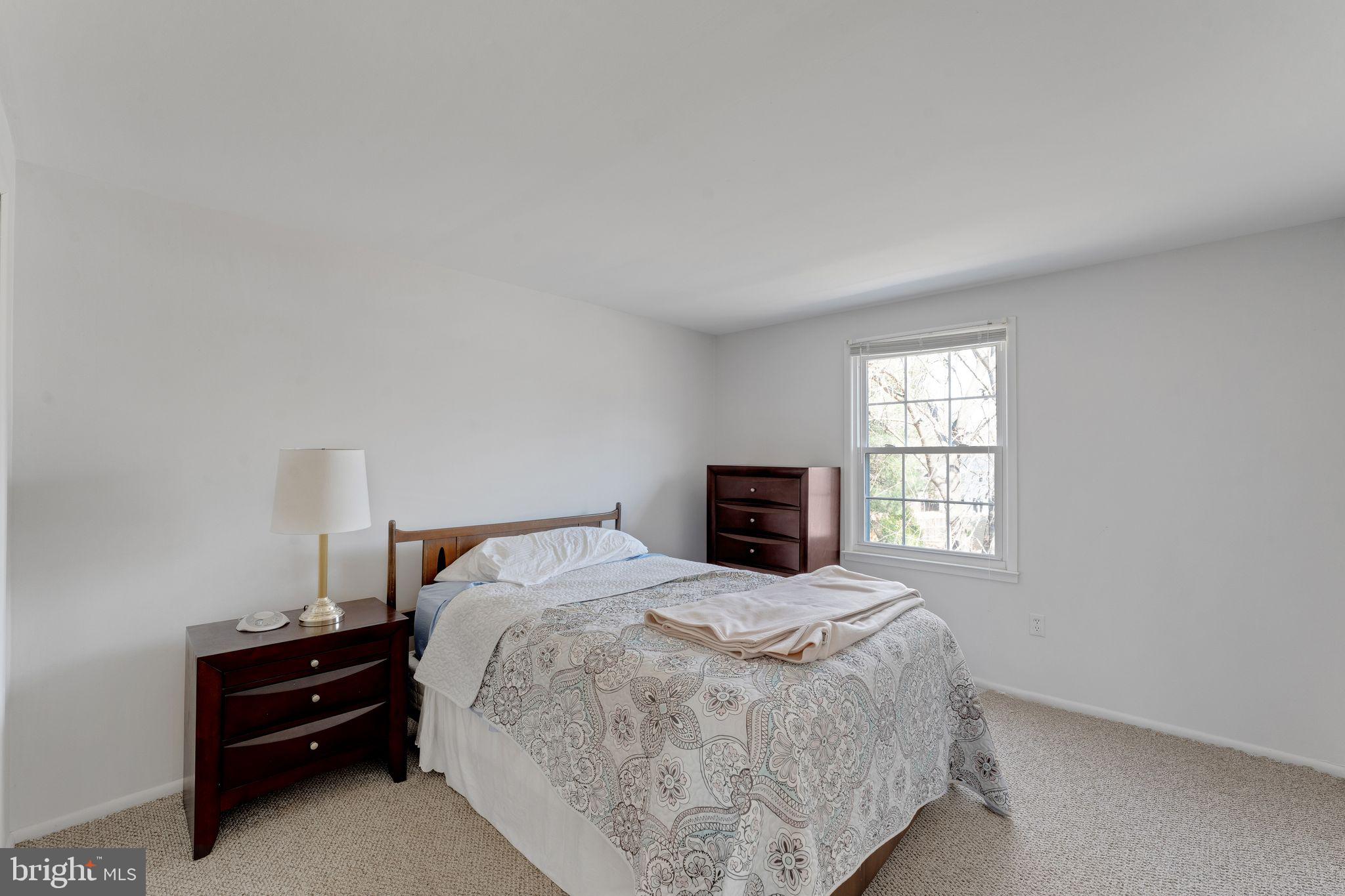 1436 Jerrold Place Crofton, MD 21114 - Photo 18 of 34 a bed sitting in a bedroom next to a window