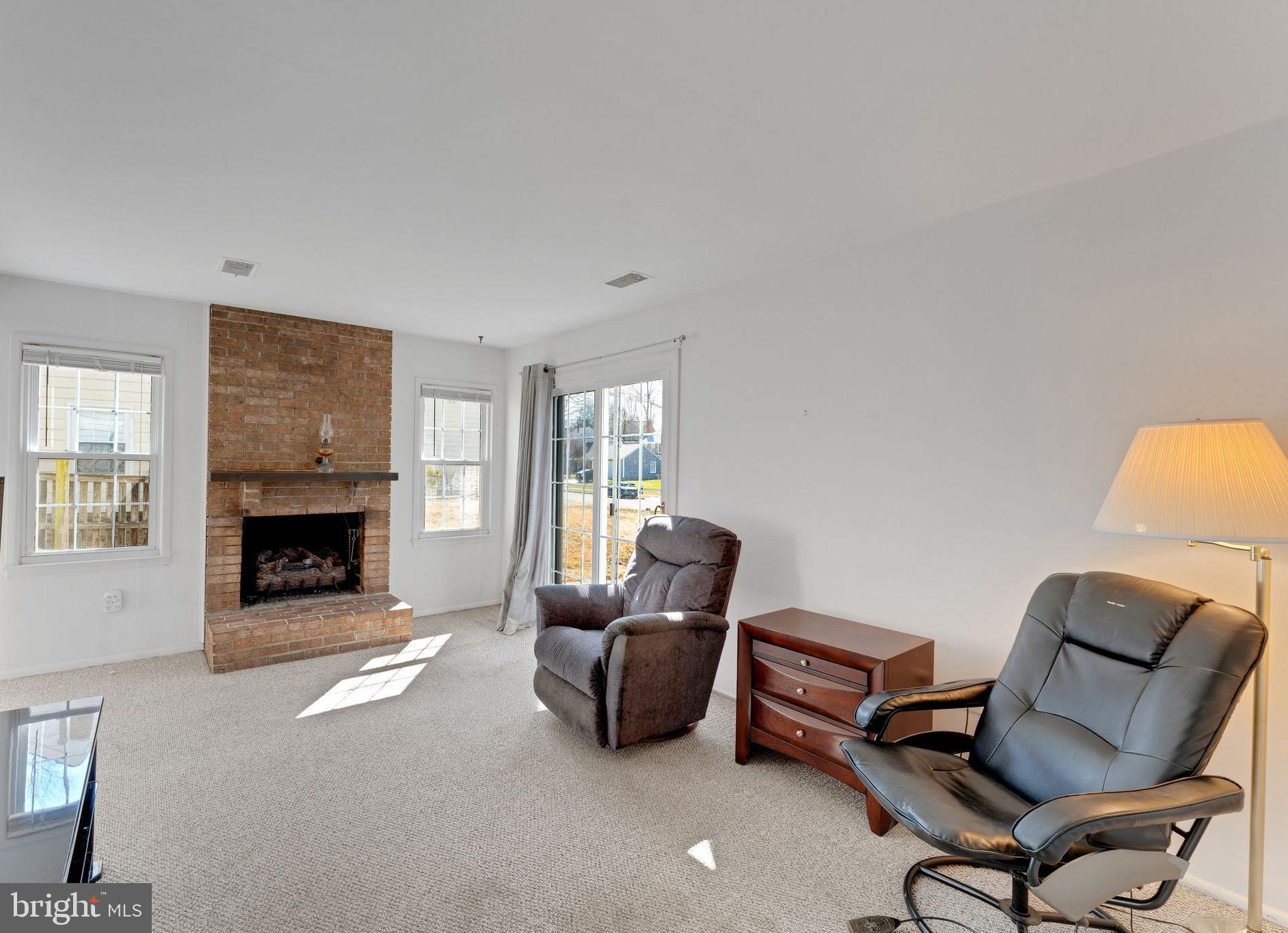 1436 Jerrold Place Crofton, MD 21114 - Photo 6 of 34 a living room with furniture and a fireplace