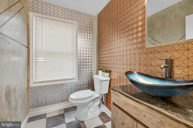 a bathroom with a toilet and a window