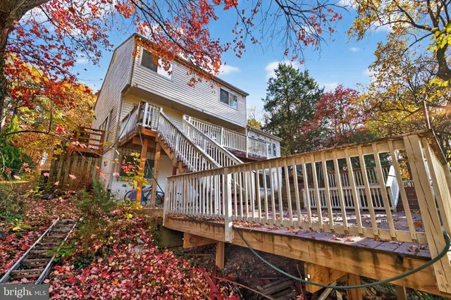 a view of balcony with wooden floor and fence