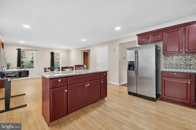 a kitchen with stainless steel appliances granite countertop a refrigerator and a sink