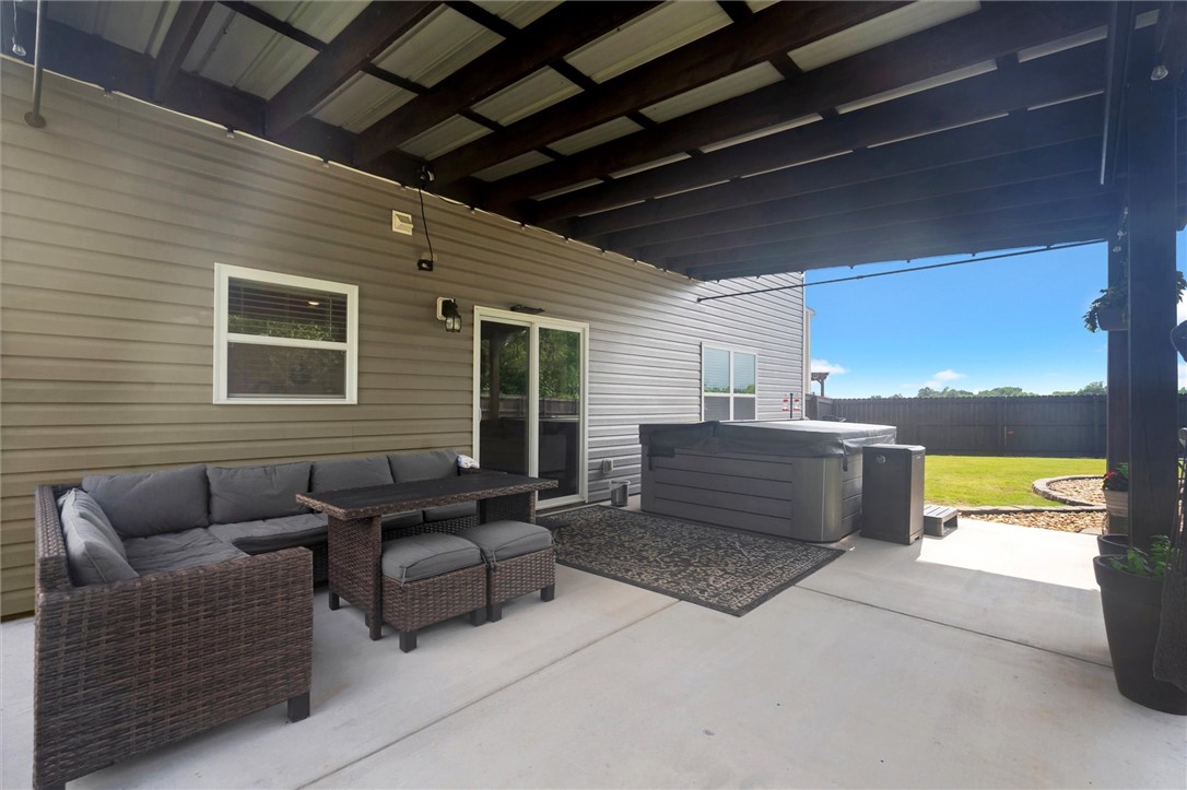 34 Karkinnen Court Pendleton, SC 29670 - Photo 26 of 36 An inviting covered patio with a spa offers relaxed outdoor living and a private fenced yard.