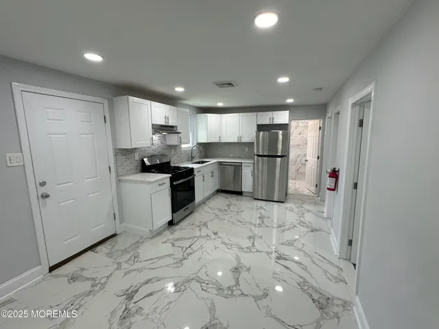 a kitchen with a refrigerator and a sink