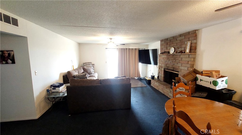 1547 Blackburn Avenue Corning, CA 96021 - Photo 22 of 51 a living room with furniture fireplace and flat screen tv