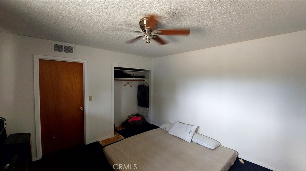1547 Blackburn Avenue Corning, CA 96021 - Photo 41 of 51 a bedroom with a bed and a chandelier fan