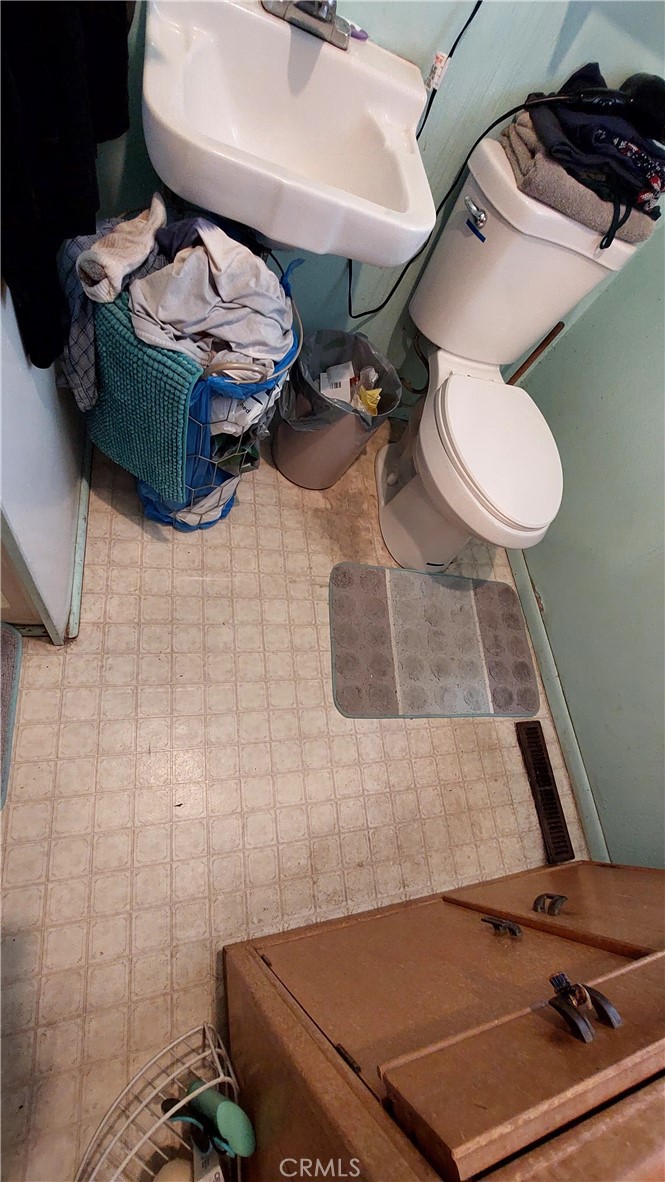 1547 Blackburn Avenue Corning, CA 96021 - Photo 46 of 51 a bathroom with a sink toilet and mirror