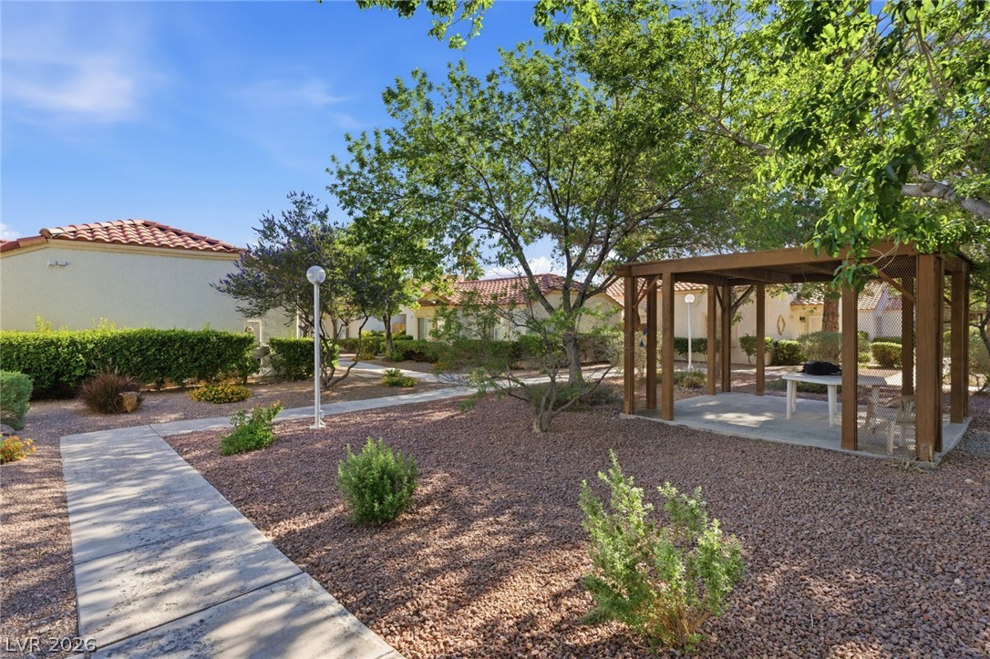 5449 Bugle Way, Unit 104 Las Vegas, NV 89108 - Photo 33 of 33 This inviting outdoor common area features a well-maintained path and a charming gazebo, perfect for relaxation.