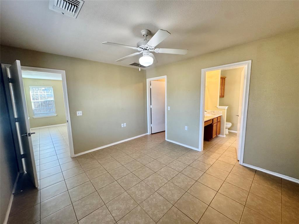 7812 Duber Lane Austin, TX 78747 - Photo 11 of 15 an empty room with fan and entrance