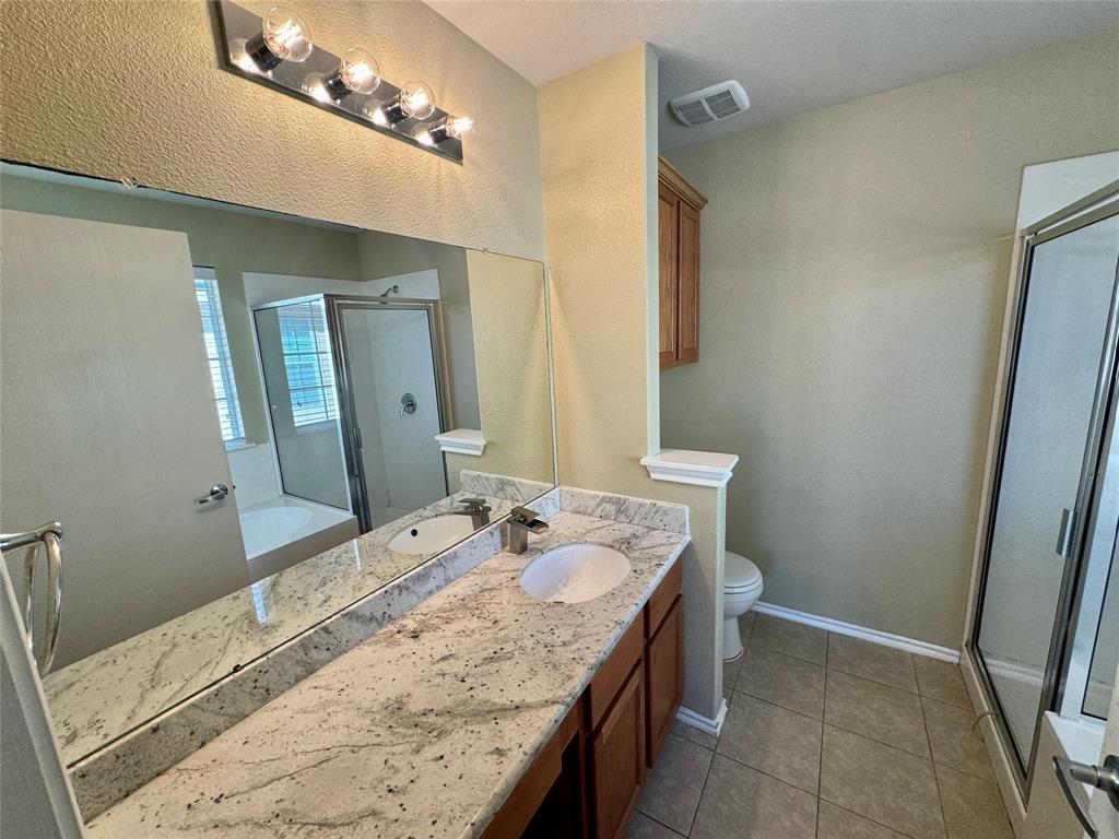 7812 Duber Lane Austin, TX 78747 - Photo 12 of 15 a bathroom with a granite countertop sink and a mirror