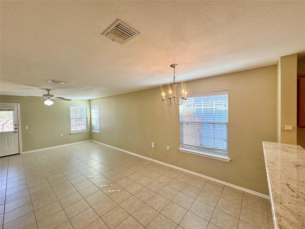 7812 Duber Lane Austin, TX 78747 - Photo 8 of 15 an empty room with windows and ceiling fan