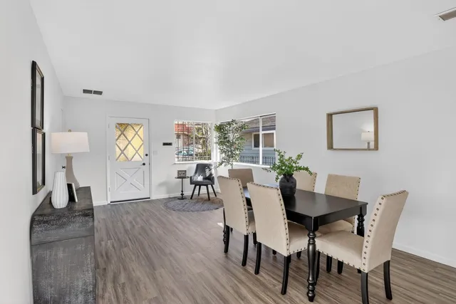a view of a dining room with furniture and wooden floor