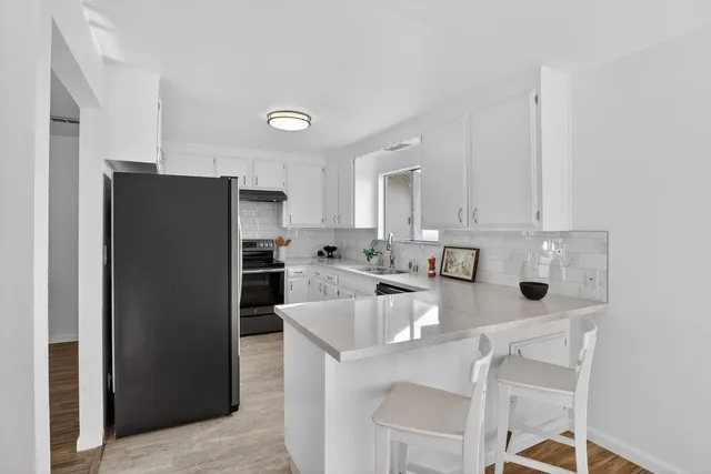 a kitchen with stainless steel appliances a refrigerator and a stove