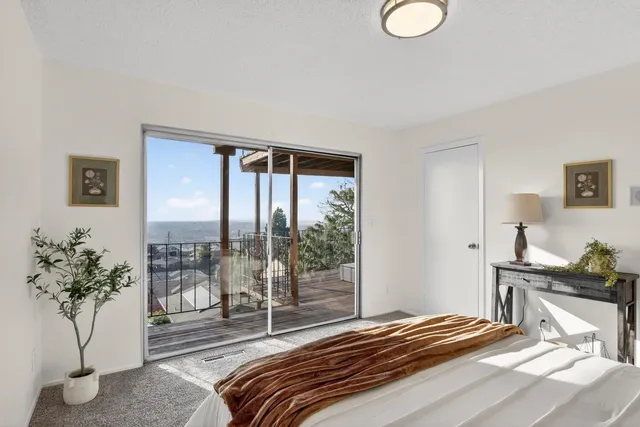 a bedroom with a bed and a potted plant