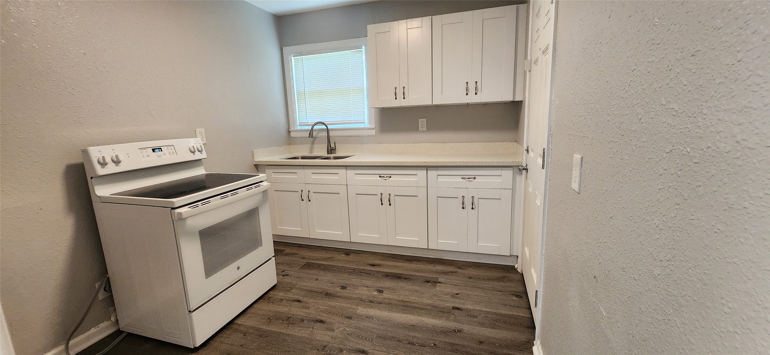 128 Huisache Street Lake Jackson, TX 77566 - Photo 11 of 23 a kitchen with white cabinets and sink