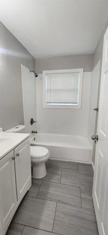 a bathroom with a toilet a sink and bathtub
