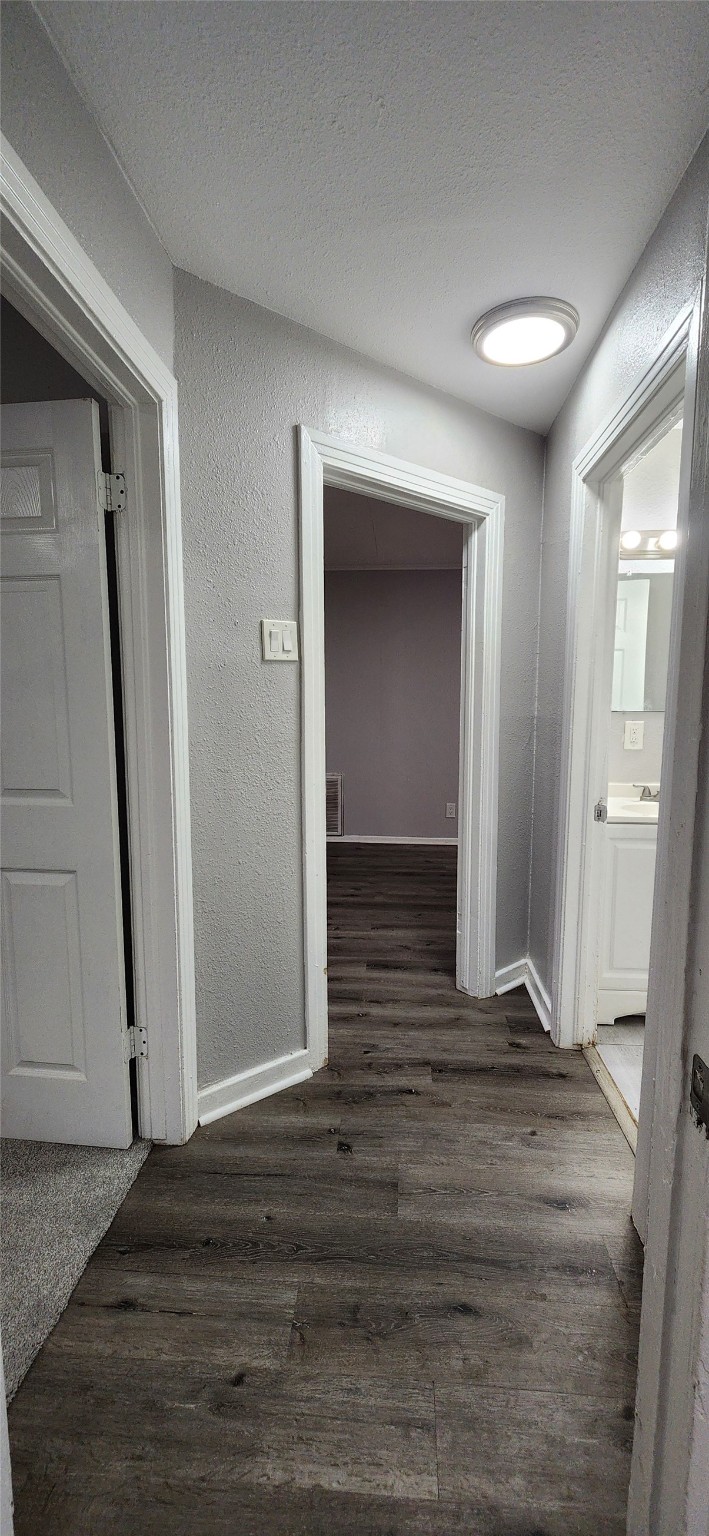 128 Huisache Street Lake Jackson, TX 77566 - Photo 16 of 23 a view of a hallway with wooden floor and a fireplace