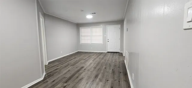 a view of a room with wooden floor and bench