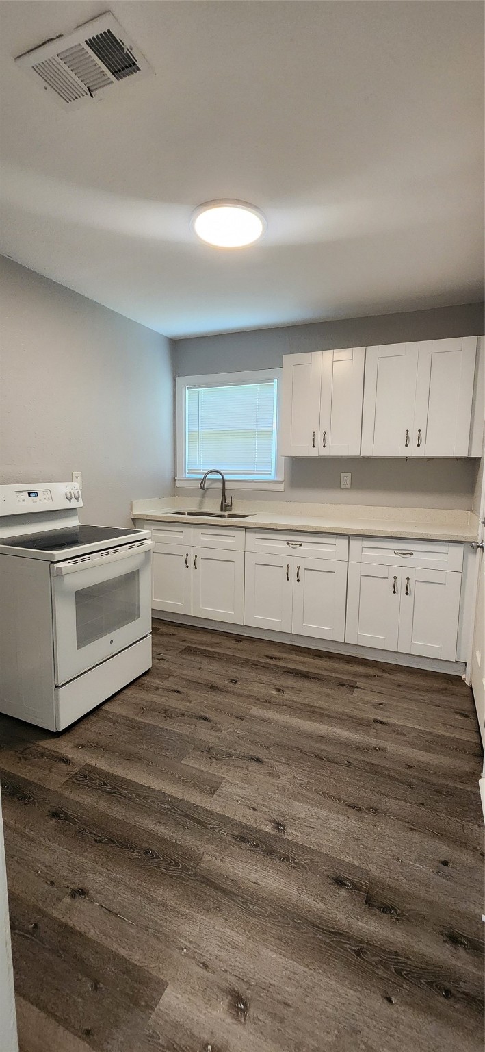 128 Huisache Street Lake Jackson, TX 77566 - Photo 9 of 23 a kitchen with granite countertop white cabinets and white appliances