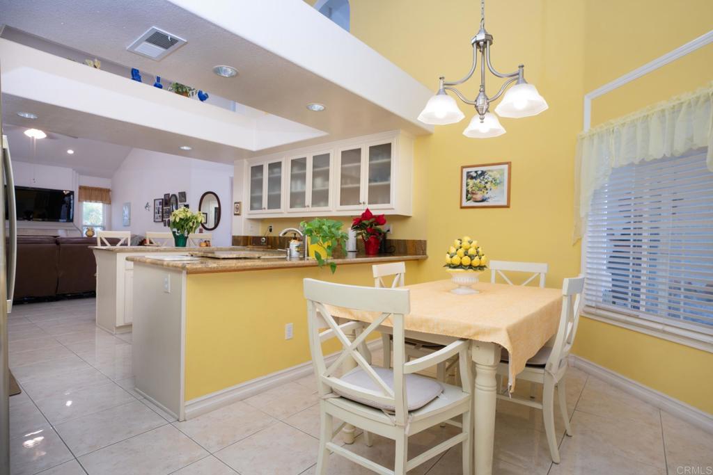 2807 Manzanita View Road Alpine, CA 91901 - Photo 11 of 36 a dining room with stainless steel appliances kitchen island granite countertop a table and chairs