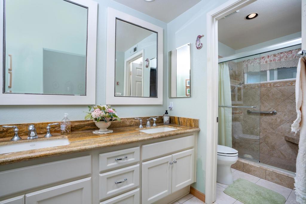 2807 Manzanita View Road Alpine, CA 91901 - Photo 21 of 36 a bathroom with a granite countertop sink a toilet and shower