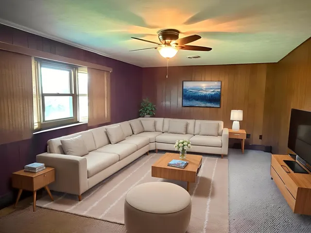 a living room with furniture a ceiling fan and a window