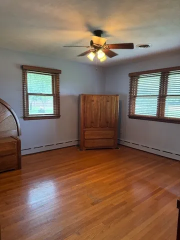 a view of wooden floor and windows in a room