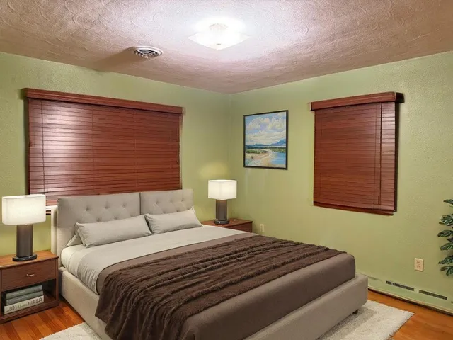 a bedroom with a bed and a night stand