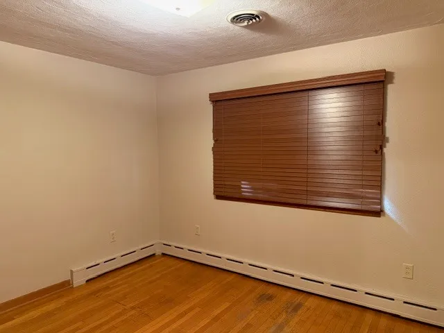 an empty room with wooden floor