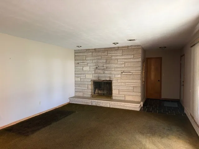 an empty room with a fireplace