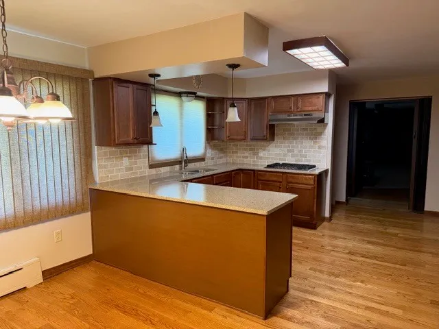 a kitchen with stainless steel appliances granite countertop a sink and a stove