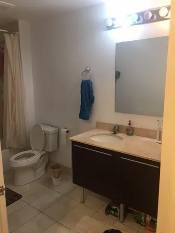 a white toilet sitting next to a bathroom sink