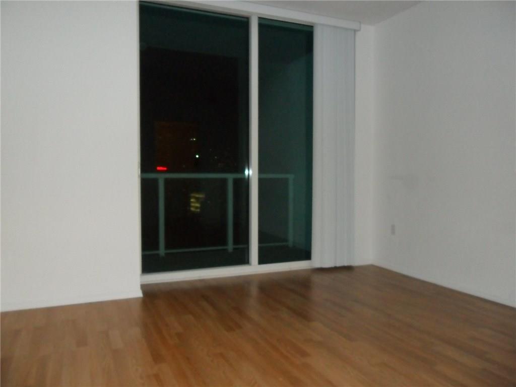 1900 North Bayshore Drive, Unit 2609 Miami, FL 33132 - Photo 31 of 36 an empty room with wooden floor