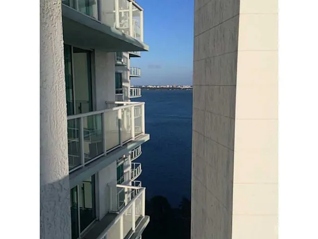 a view of a livingroom with wooden floor and a window