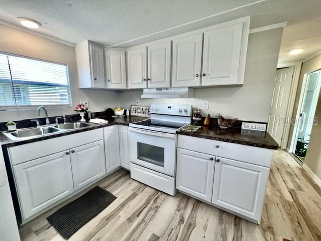 10826 Tioga Drive Port Richey, FL 34668 - Photo 11 of 59 a white kitchen with sink and cabinets