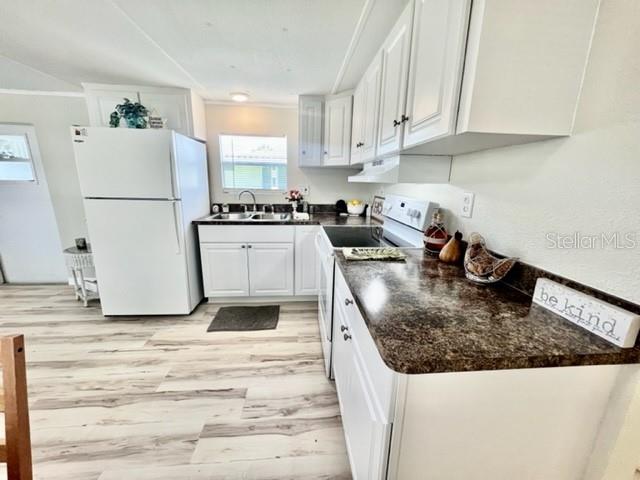 10826 Tioga Drive Port Richey, FL 34668 - Photo 12 of 59 a kitchen with a sink a stove and refrigerator