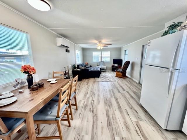 10826 Tioga Drive Port Richey, FL 34668 - Photo 16 of 59 a view of a dining room with furniture wooden floor and a chandelier