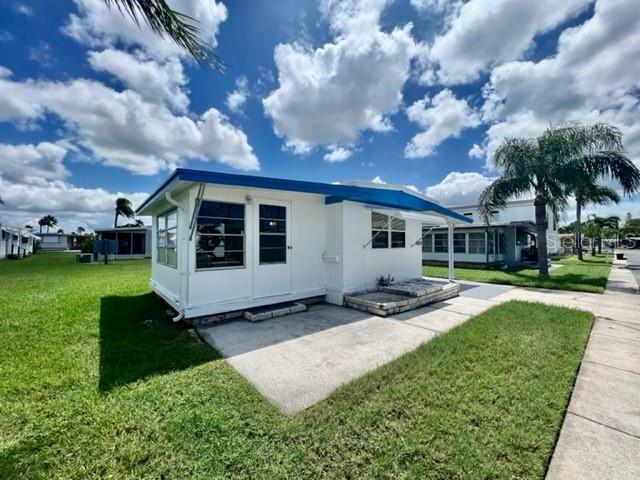 10826 Tioga Drive Port Richey, FL 34668 - Photo 2 of 59 a front view of a house with garden
