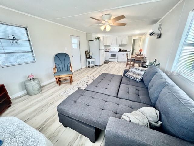 10826 Tioga Drive Port Richey, FL 34668 - Photo 24 of 59 a living room with furniture and wooden floor