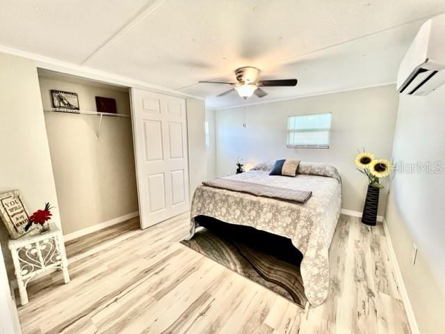 10826 Tioga Drive Port Richey, FL 34668 - Photo 29 of 59 a bedroom with a bed and wooden floor