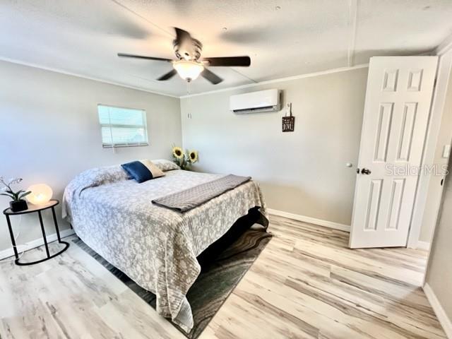 10826 Tioga Drive Port Richey, FL 34668 - Photo 30 of 59 a bedroom with a bed and a mirror on the dresser