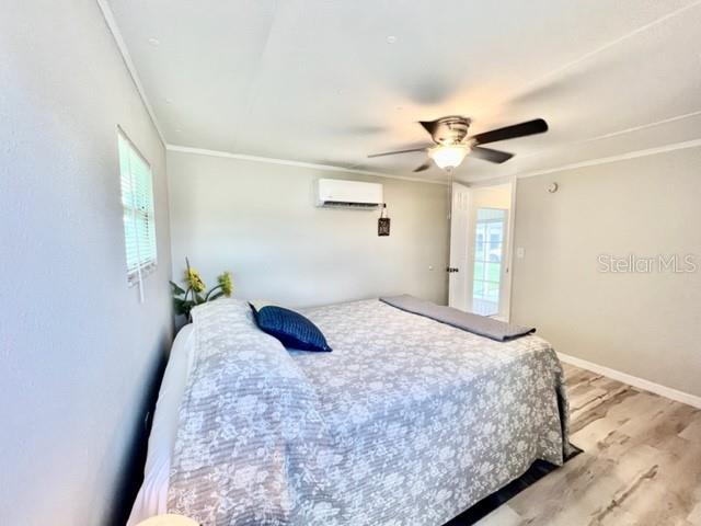 10826 Tioga Drive Port Richey, FL 34668 - Photo 31 of 59 a bedroom with a bed and a chandelier