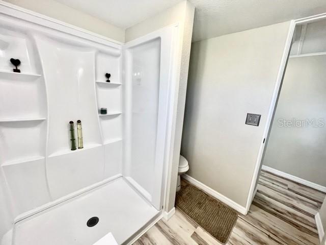 10826 Tioga Drive Port Richey, FL 34668 - Photo 38 of 59 a bathroom with a tub and shower