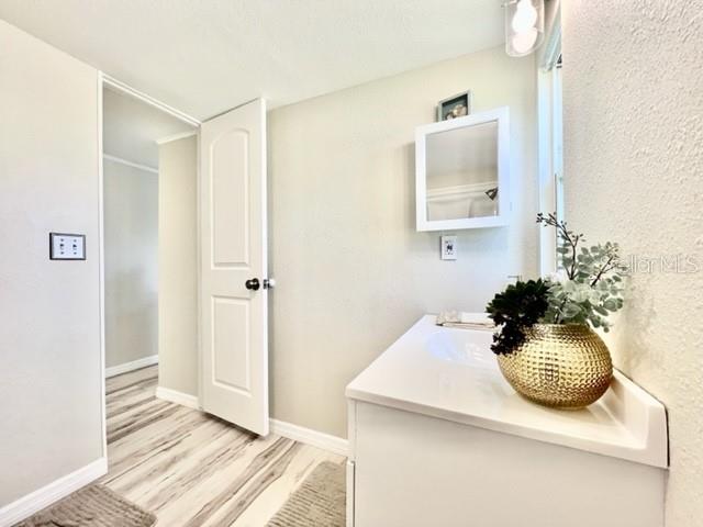 10826 Tioga Drive Port Richey, FL 34668 - Photo 40 of 59 a bathroom with a sink and mirror