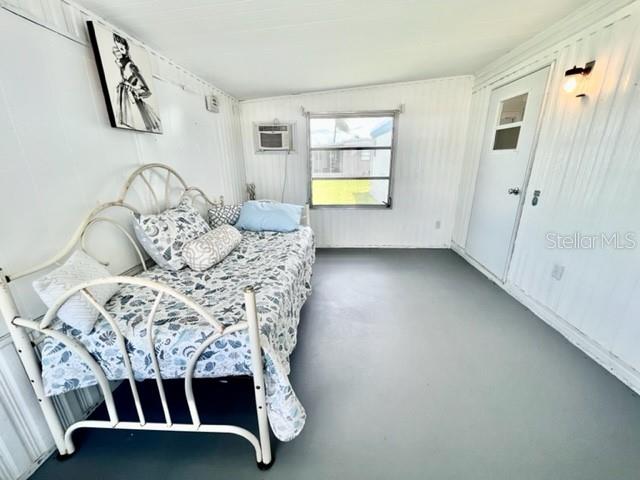 10826 Tioga Drive Port Richey, FL 34668 - Photo 43 of 59 a bedroom with a bed and a window