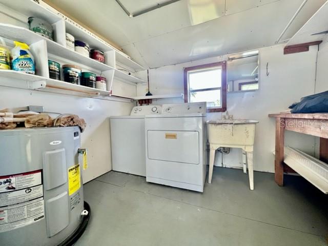 10826 Tioga Drive Port Richey, FL 34668 - Photo 44 of 59 a utility room with cabinets dryer and washer