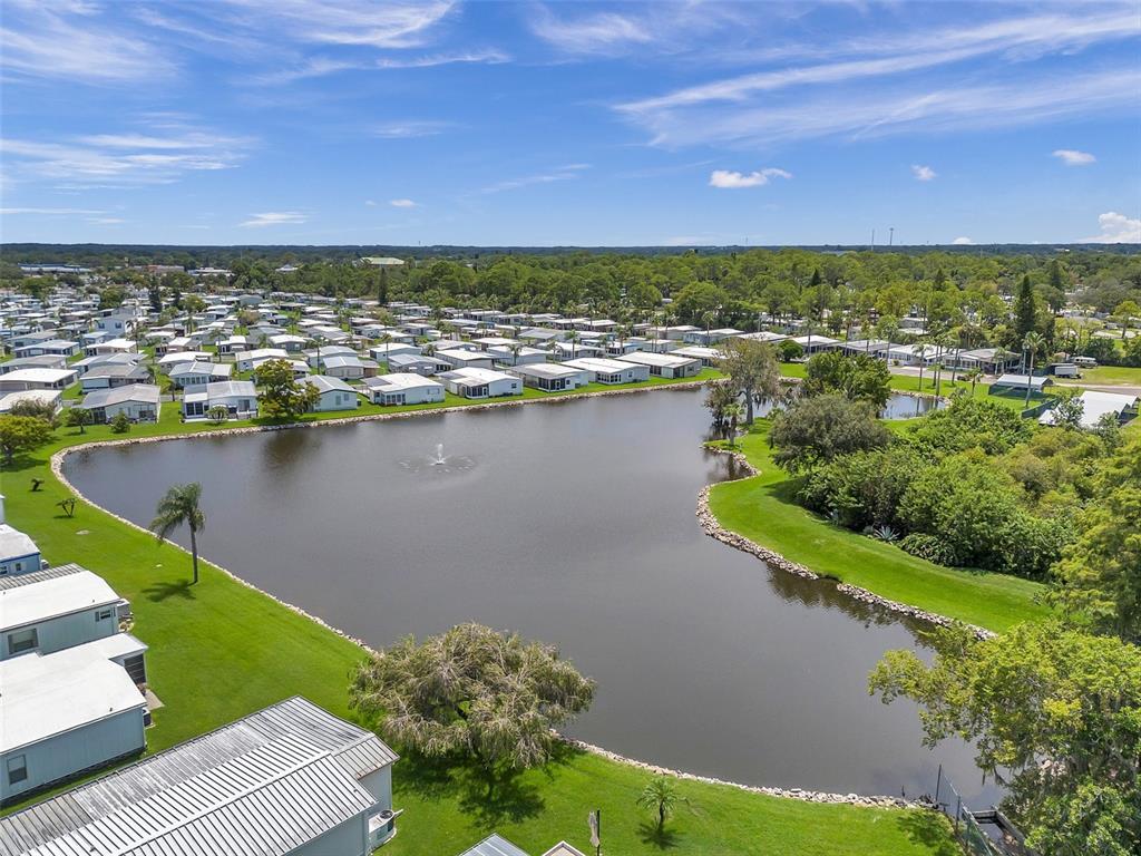 10826 Tioga Drive Port Richey, FL 34668 - Photo 48 of 59 an aerial view of residential building with outdoor space and lake view