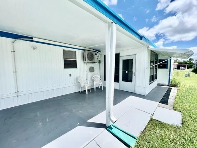 10826 Tioga Drive Port Richey, FL 34668 - Photo 5 of 59 a view of a patio with table and chairs and potted plants