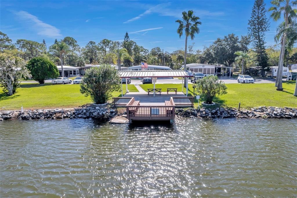10826 Tioga Drive Port Richey, FL 34668 - Photo 52 of 59 an aerial view of a house with outdoor space swimming pool and lake view